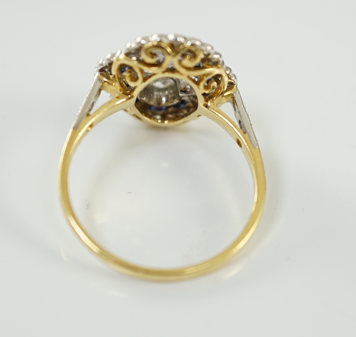 A modern 18ct gold, sapphire and diamond set quatrefoil shaped cluster ring